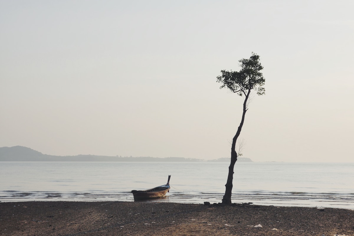 Longtail boat on quiet Koh Lanta beach — Thailand in August