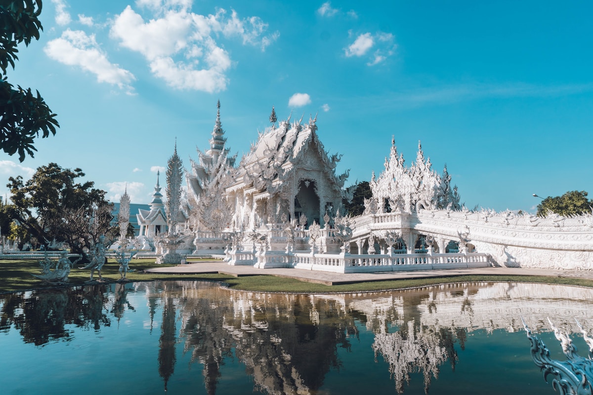 Wat Rong Khun White Temple reflected in pond, Chiang Rai — December
